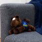 Small Chestnut horse stuffed animal wearing a royal blue branded mane 'n tail saddle. Standing on the couch