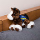 Small brown Clydes horse stuffed animal wearing a royal blue branded mane 'n tail saddle. Standing on a cushion
