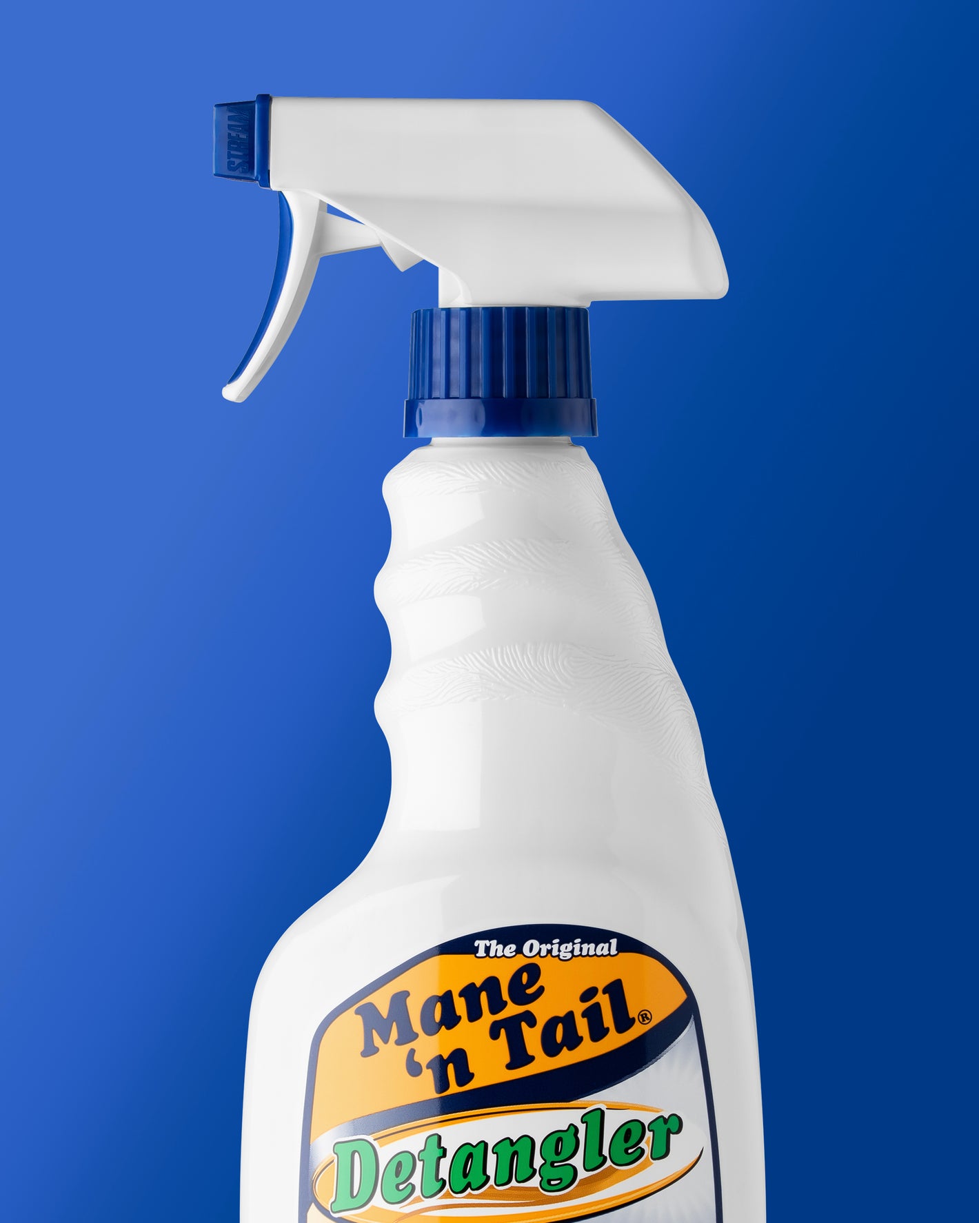 Mane 'n Tail detangler spray bottle on a blue background