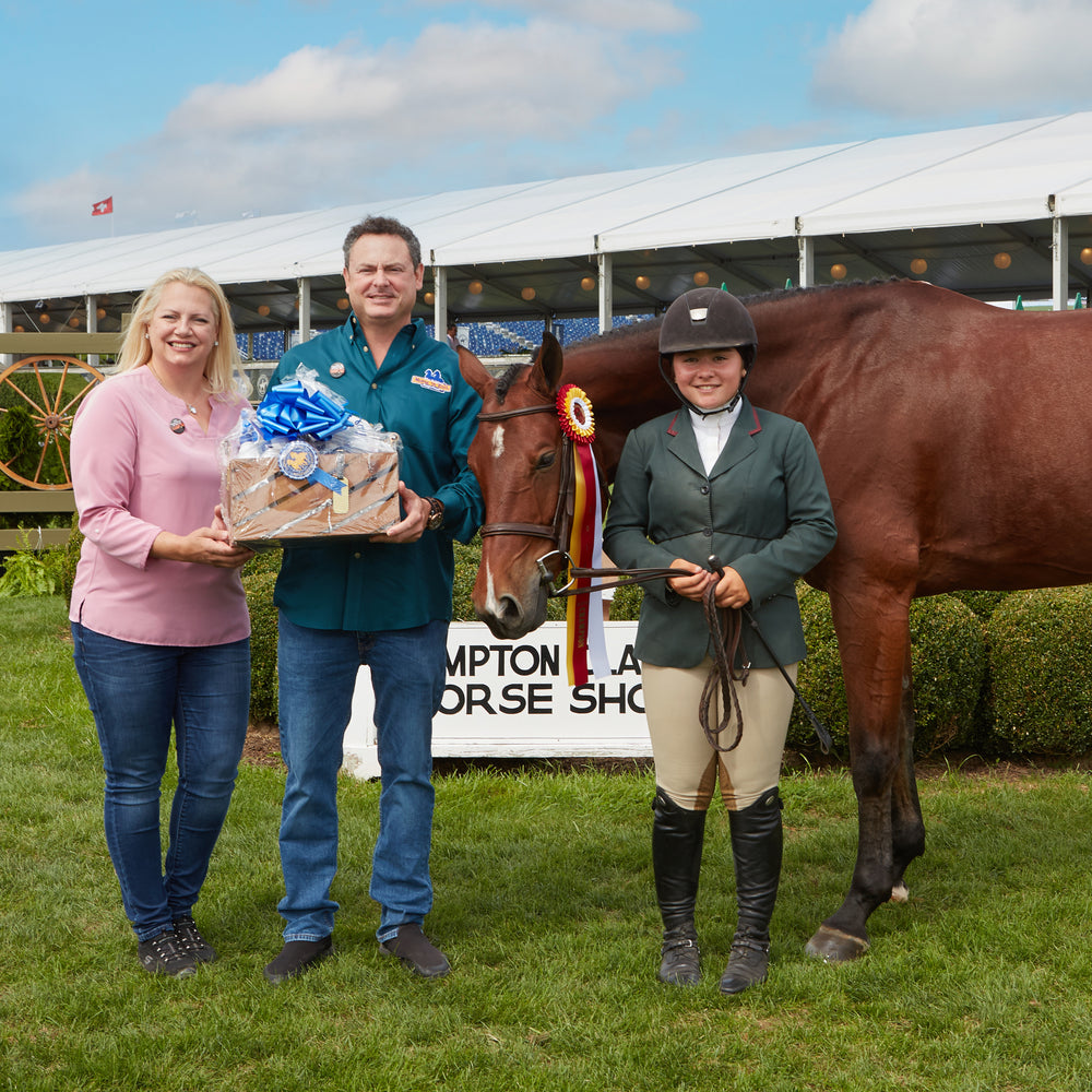 A photo Ashyn, Devon, and a winner. Ashyn and Devon are holding a basket for the winter