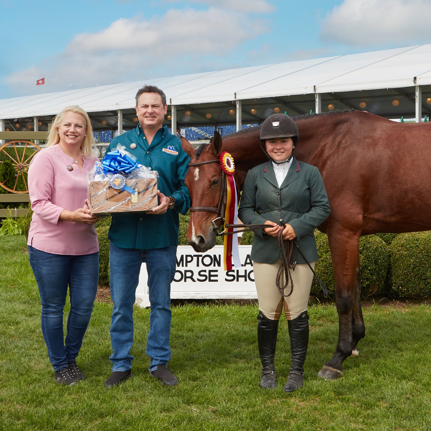A photo Ashyn, Devon, and a winner. Ashyn and Devon are holding a basket for the winter